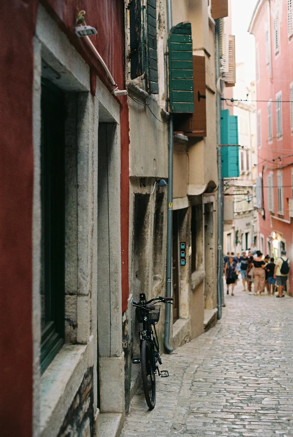 Bicycle and pedestrians on a colourful cobbled lane