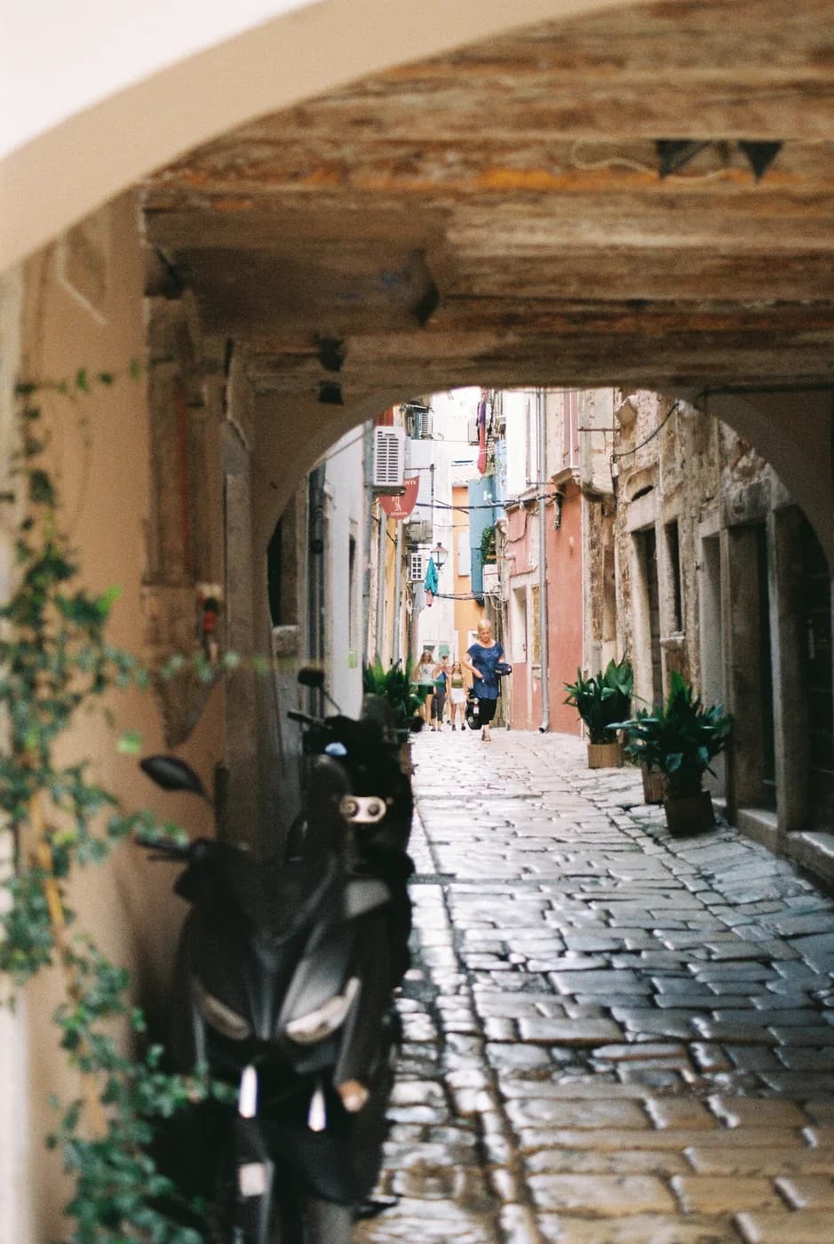 Cobbled lane viewed through a shaded archway