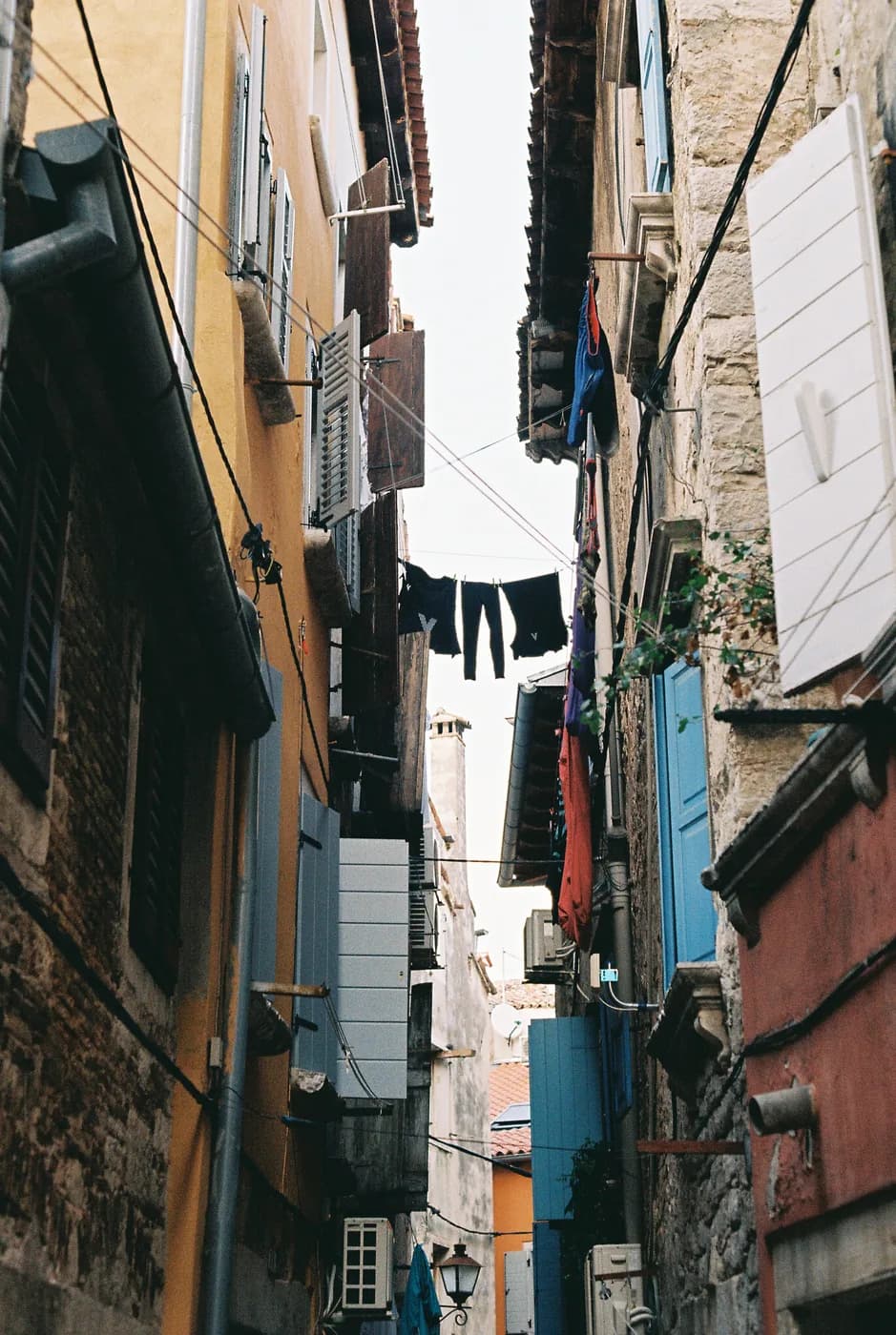 Laundry hanging between closely spaced buildings