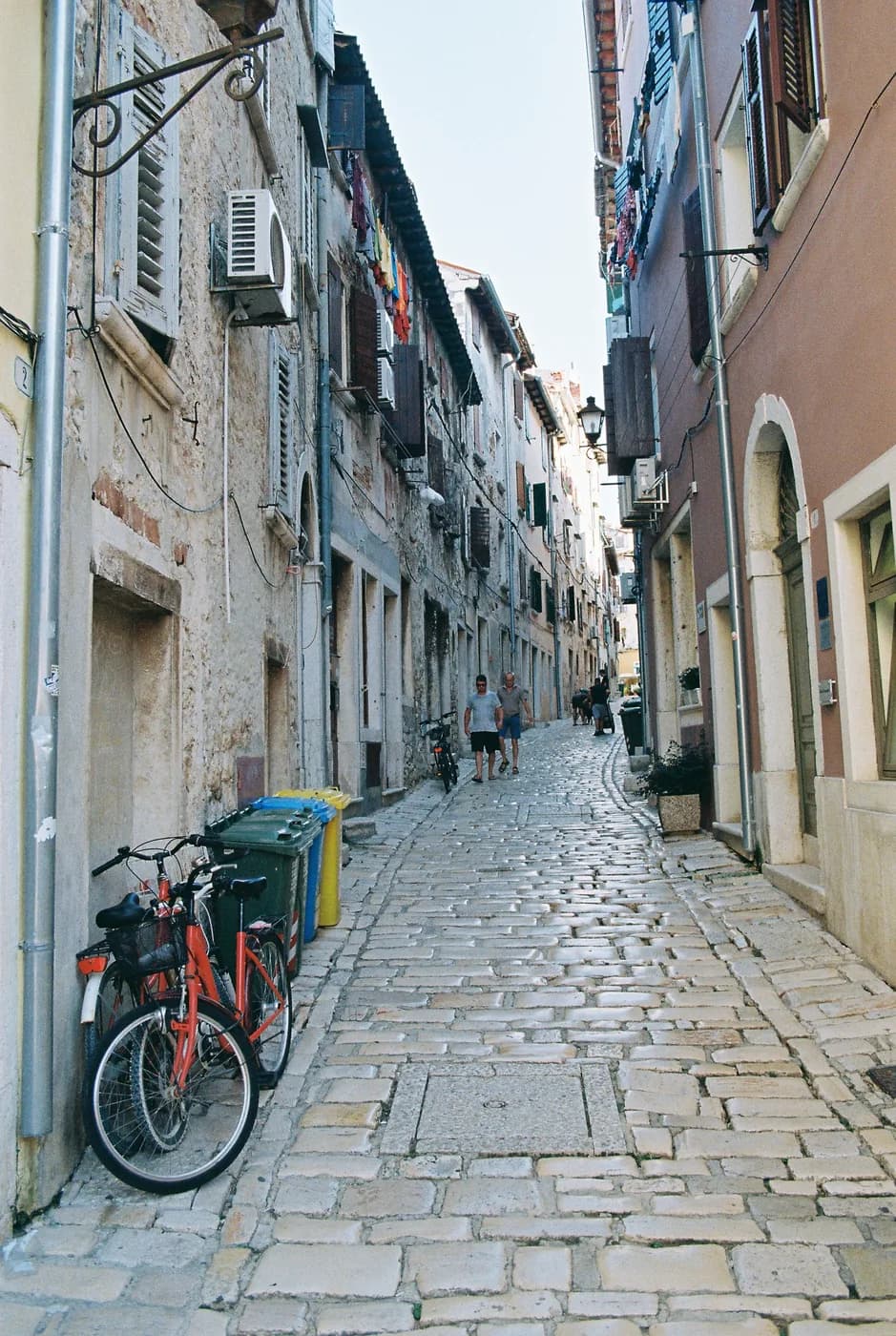 Bicycle parked along a quiet narrow street