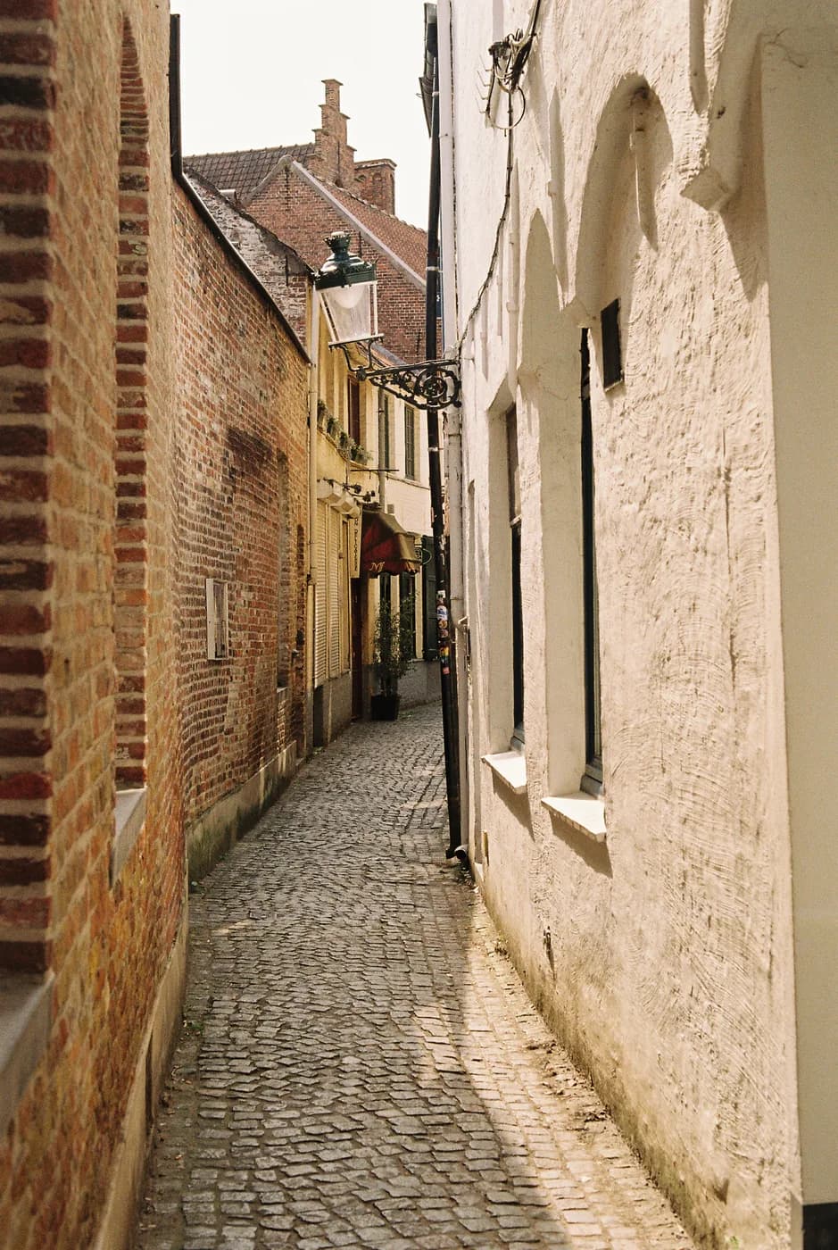 Narrow passage between old brick and stone walls