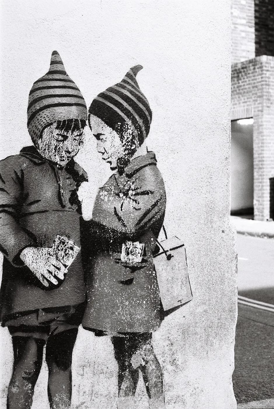 High-contrast black-and-white portrait of two children